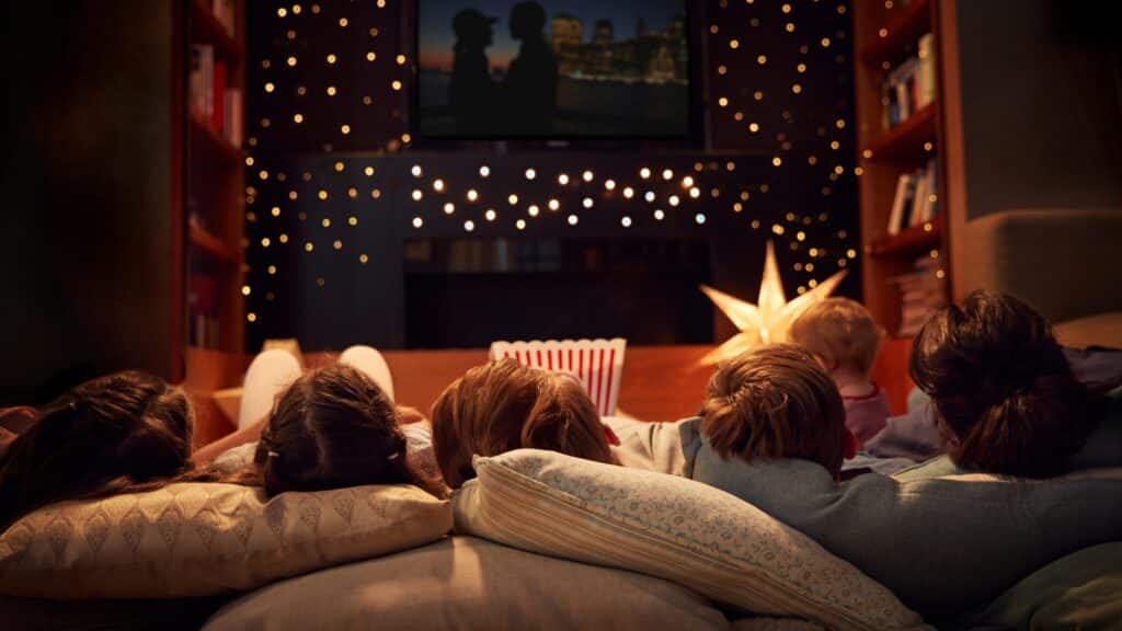 Kids watching movie with string lights