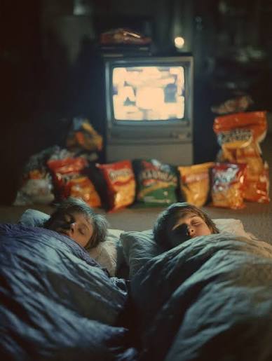 Kids asleep in front of TV with snack wall