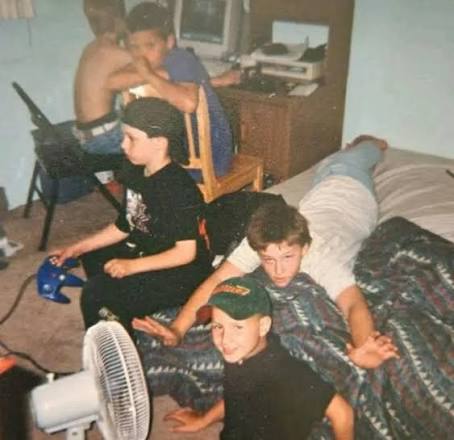 90s kids gaming on bed